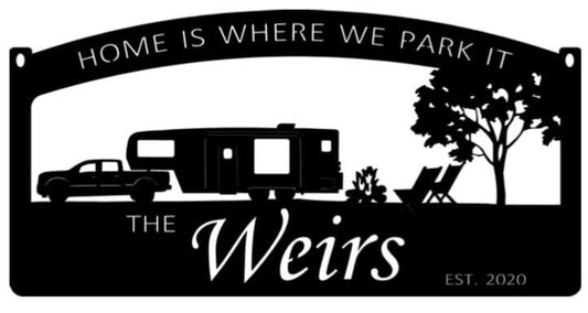 Metal camper sign with campfire and chairs
